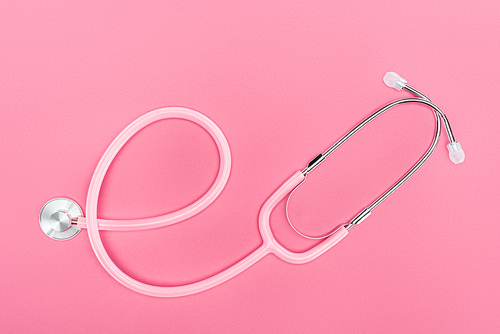 top view of stethoscope on pink background, breast cancer concept