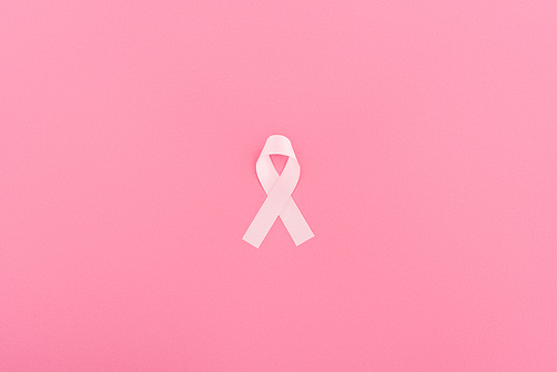 top view of pink breast cancer sign on pink background
