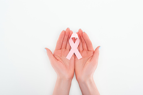 partial view of woman holding in hands pink breast cancer sign on white background