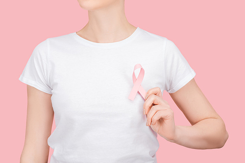 partial view of woman in white t-shirt with pink breast cancer sign isolated on pink