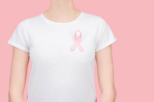 cropped view of woman in white t-shirt with pink breast cancer sign isolated on pink