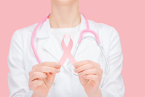 selective focus of doctor in white coat holding pink breast cancer sign isolated on pink