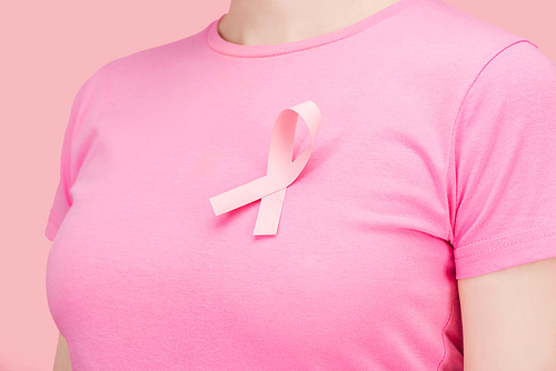 close up view of woman in pink t-shirt with breast cancer sing isolated on pink