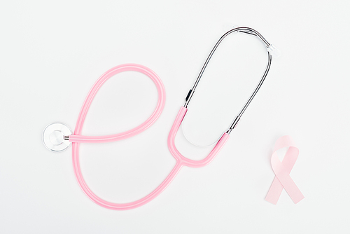 top view of stethoscope and pink breast cancer bow on white background