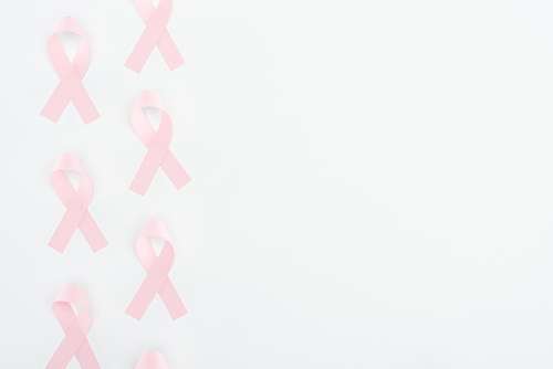 top view of silk pink breast cancer signs on white background with copy space