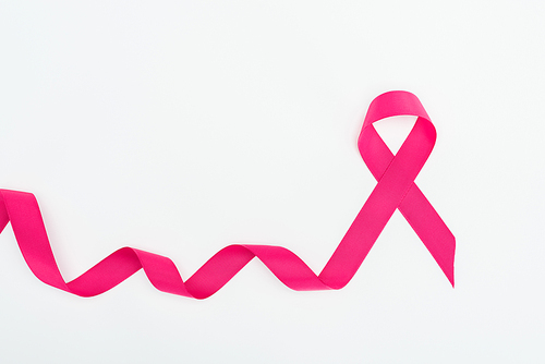 top view of curved crimson breast cancer ribbon on white background