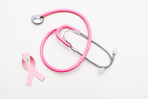 Top view of stethoscope and ribbon of breast cancer awareness isolated on white