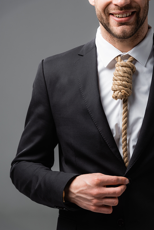 cropped view of smiling businessman with rope instead of tie isolated on grey