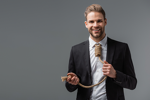 happy businessman with rope instead of tie  isolated on grey