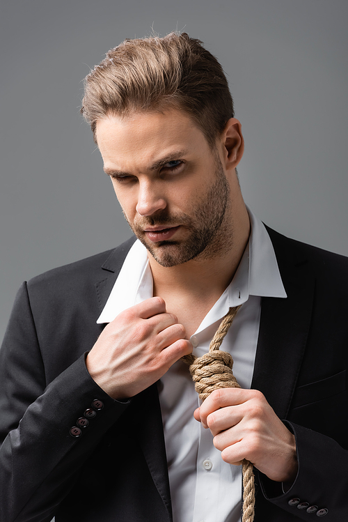 depressed businessman  while touching rope on neck isolated on grey