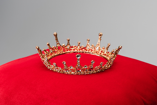 luxury crown on red velvet cushion isolated on grey