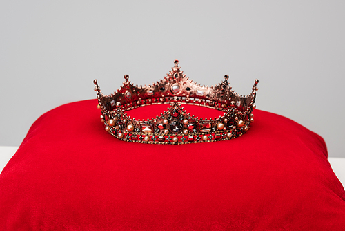 luxury royal crown on red cushion isolated on grey