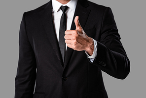 partial view of businessman in black suit showing thumb up isolated on grey