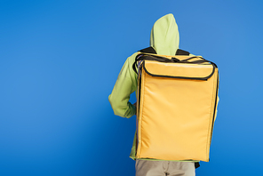 back view of delivery man carrying thermo backpack on blue background