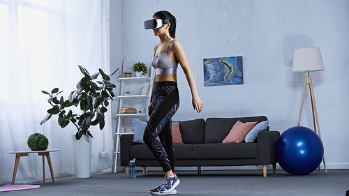 happy young woman in sportswear and vr headset working out at home
