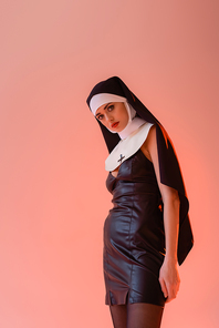 young nun in sexy dress  isolated on pink