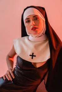 sensual nun in sexy dress  isolated on pink