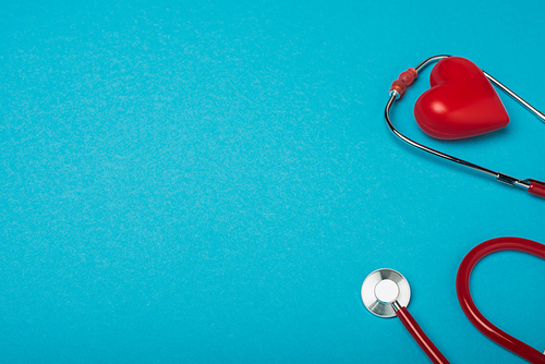 Decorative heart and stethoscope on blue background, world health day concept