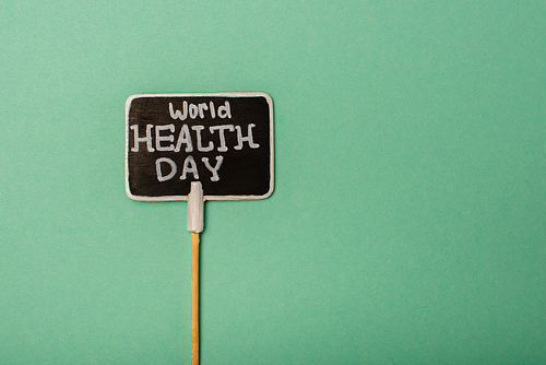 Top view of card with world health day lettering on green background