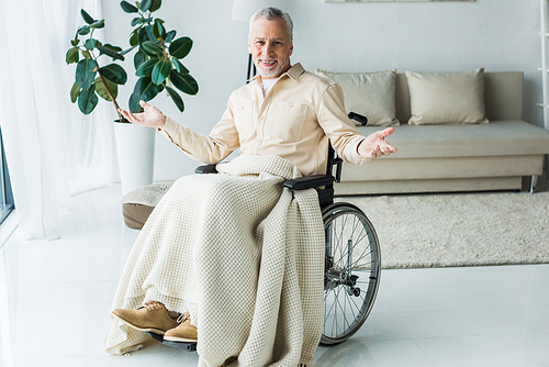happy disabled senior man sitting in wheelchair with outstretched hands
