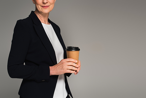 Cropped view of manager holding coffee to go isolated on grey