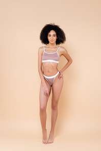 full length view of slim african american woman in underwear on beige