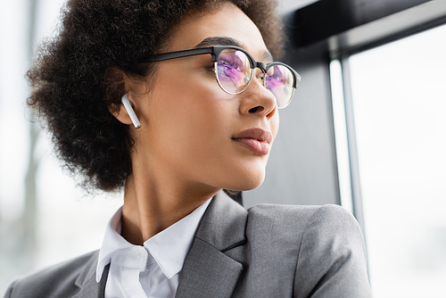 African american businesswoman listening music in earphone