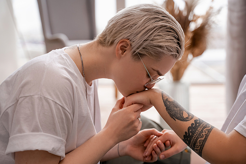 young lesbian woman  hand of tattooed girlfriend