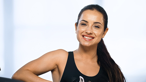 happy and sporty woman smiling in gym
