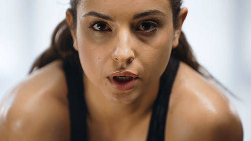 close up of sweaty sportswoman working out in gym