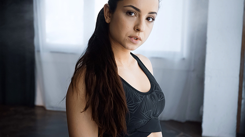 sporty young woman in crop top  in gym