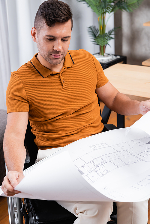 disabled engineer looking at blueprint while working at home
