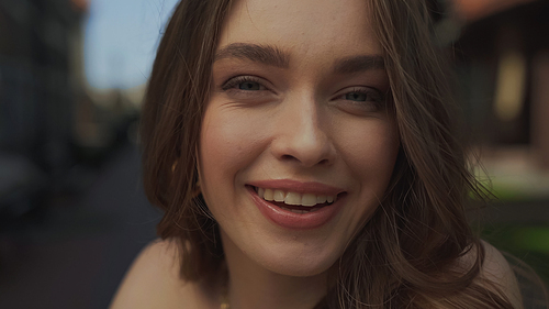 close up of happy young woman smiling at camera