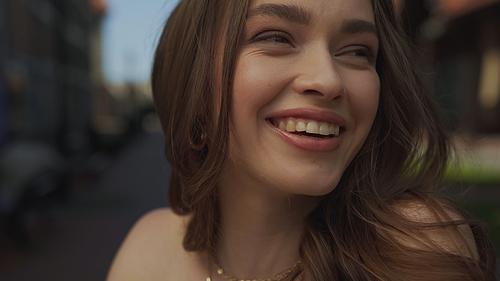 close up of happy young woman smiling outside