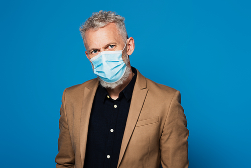 middle aged man in protective medical mask  isolated on blue