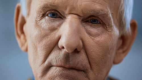 close up view of elderly man  on grey background