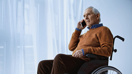 elderly man in . speaking on cellphone at retirement home