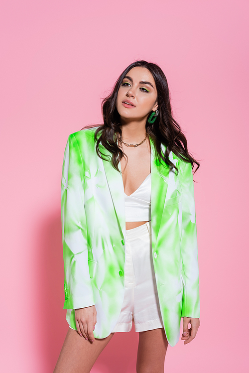 Stylish woman posing on pink background