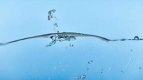 wavy transparent water on blue background with splash