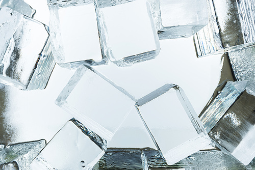 top view of transparent clear square ice cubes on mirror