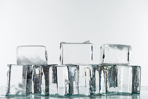 melting transparent clear square ice cubes isolated on white