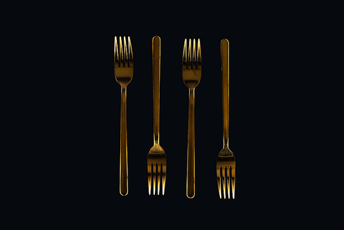 flat lay of metal forks isolated on black
