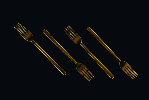 four metal forks isolated on black