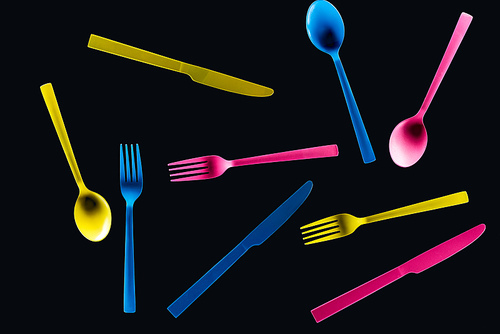 bottom view of colorful plastic cutlery isolated on black