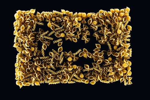 top view of uncooked pasta in rectangle form isolated on black