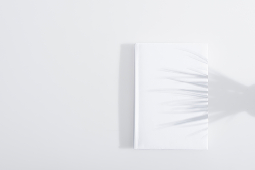 shadow on hardcover of book on white background
