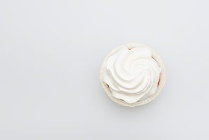 top view of sweet cupcake with icing on top isolated on white