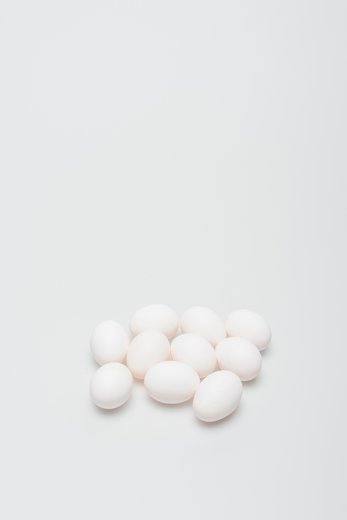 raw and organic eggs on white background