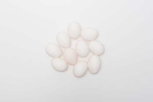 top view of raw and organic eggs isolated on white