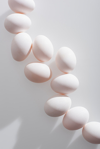 top view of organic eggs in shell on white background